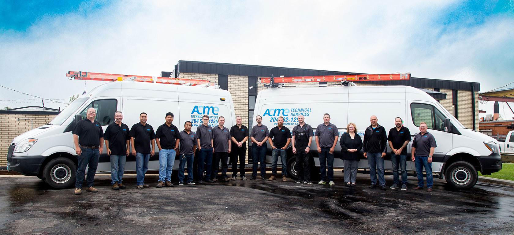 ACME Technical Services team photo in front of our vehicles and building.